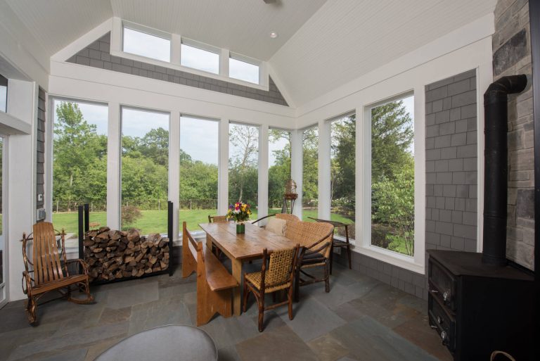 Back sunroom with vintage stove and furniture