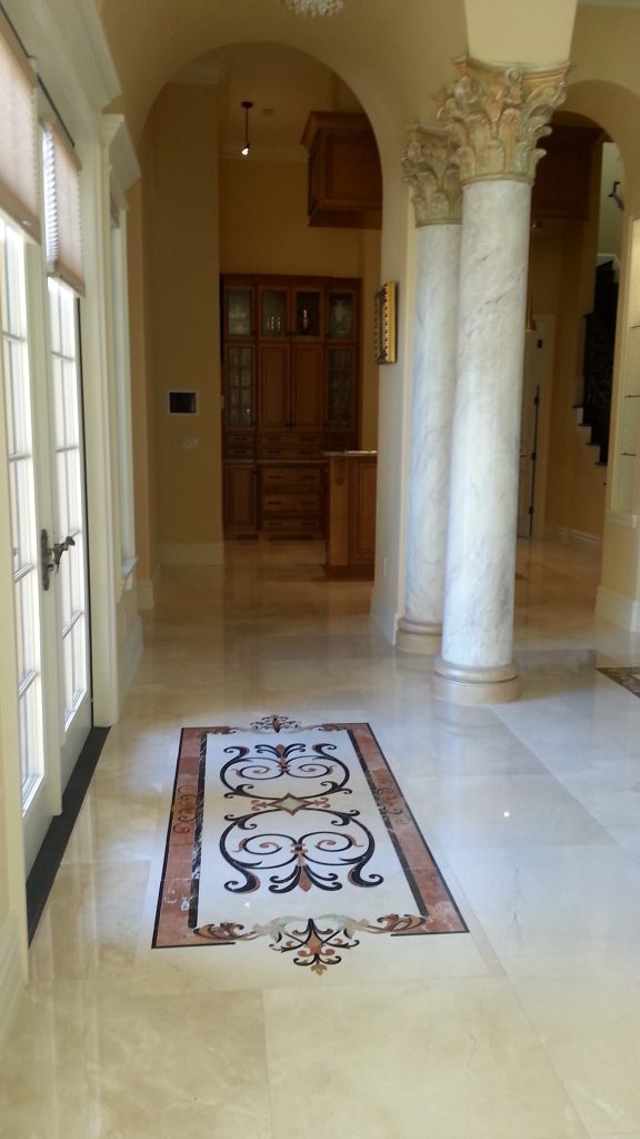Back yard entrance. Tile Rug incorporating stones found through out residence. Photo by Owner Reza