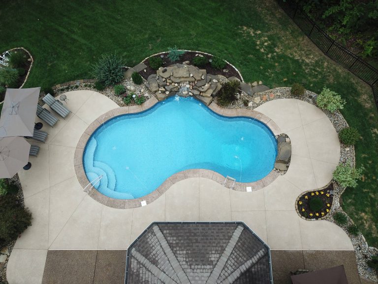 Backyard Oasis at its finest... Custom water feature, jump rock, deck jets, stamped cantilevered coping, vinyl liner steps and bench does not disappoint. by Bi-State Pool & Spa | Pool design | Pool Contracting | Swimming Pool Ideas | Swimming Pool Design Ideas