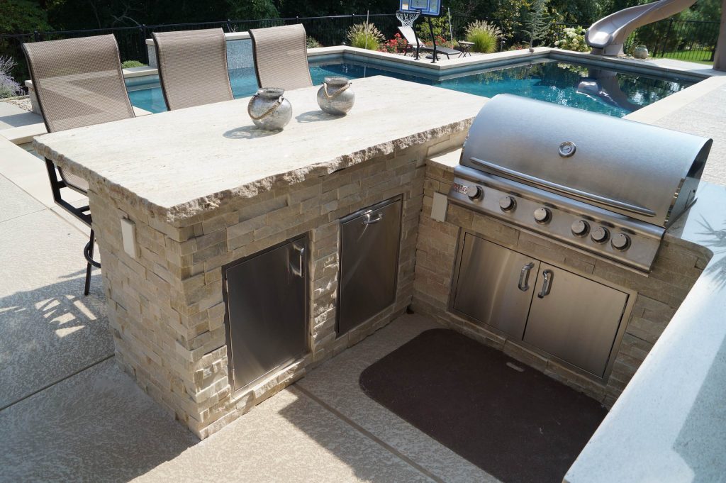 Bar height and working height counters in this outdoor kitchen make it the perfect space for grilling and entertaining | Green Guys