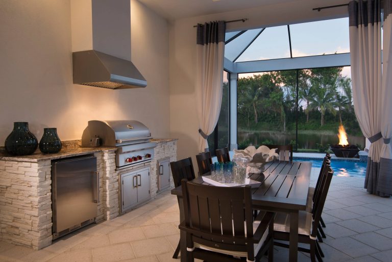 Beach style backyard patio kitchen photo in Miami