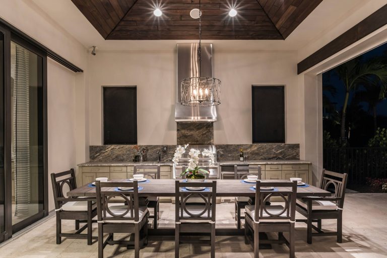 Beach style backyard patio kitchen photo in Miami with a roof extension