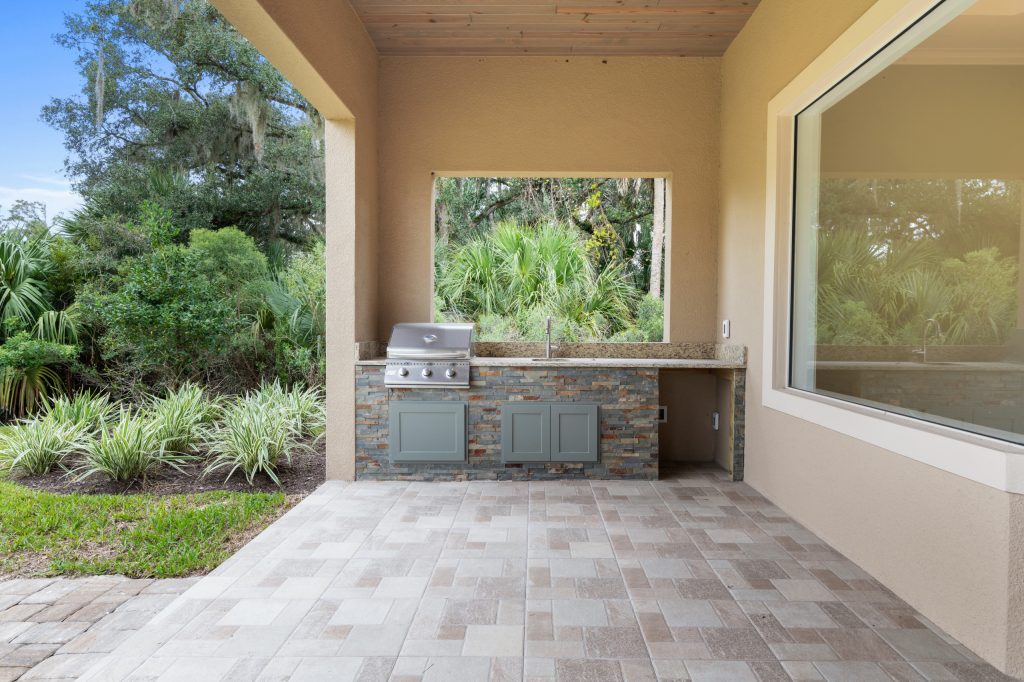 Beach style outdoor kitchen porch idea in Orlando by Stoughton & Duran Custom Homes | Outdoor Photos | Porch | Landscaping | Landscape Design | Outdoor Living Space | Porch Design Ideas | Outdoor Living Space Ideas | Backyard Design