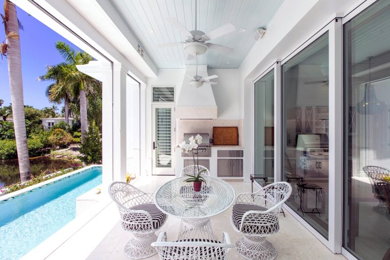 Beach style porch idea in Miami with a roof extension by Kukk Architecture & Design P.A. | Outdoor Photos | Porch | Landscaping | Landscape Design | Outdoor Living Space | Porch Design Ideas | Outdoor Living Space Ideas | Backyard Design
