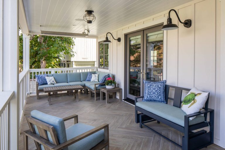 Beach style tile porch photo in Los Angeles with a roof extension by Christine Vroom Interiors | Outdoor Photos | Porch | Landscaping | Landscape Design | Outdoor Living Space | Porch Design Ideas | Outdoor Living Space Ideas | Backyard Design