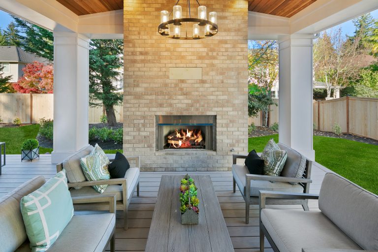 Beautiful outdoor fireplace with brick surround.