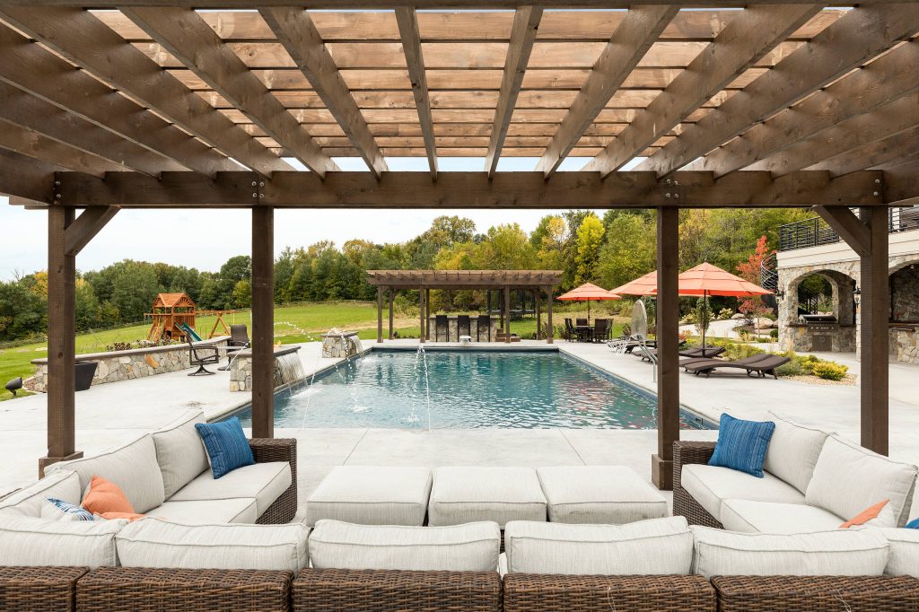 Beautiful outdoor living room overlooking the custom pool. Photo by Spacecrafting