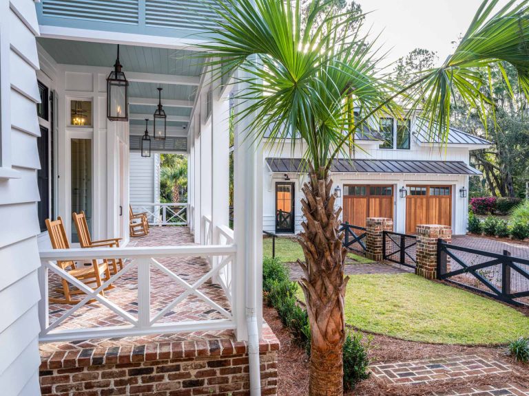 Bevelo copper gas lanterns, herringbone brick floor, and "Haint blue" tongue and groove ceiling.