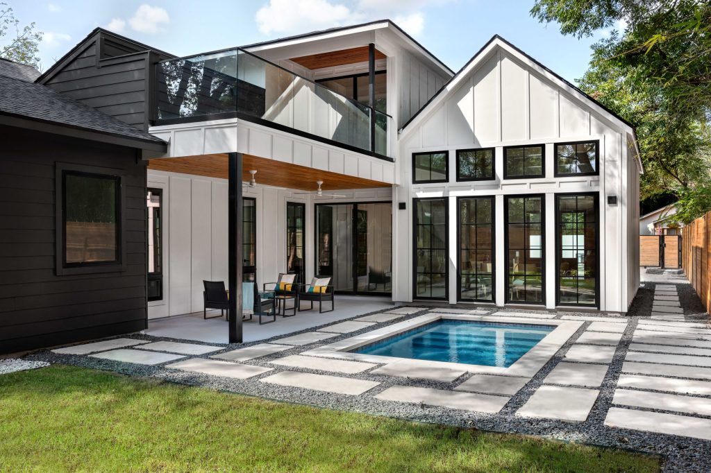 Black and white home exterior with a plunge pool in the backyard.