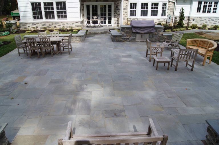 Blue-Blue Pa bluestone patio coupled with a built in grill outside this Philadelphia Main Line home