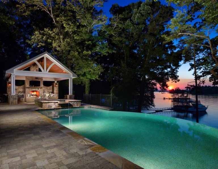 Breathtaking view of infinity edge pool and spa overlooking Lake Lanier at sunset.