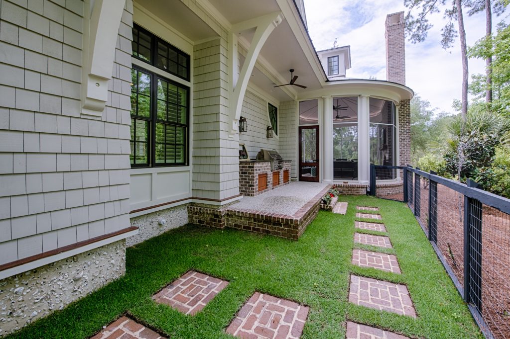 Brick grill island, stainless steel gas grill, and tabby floor.