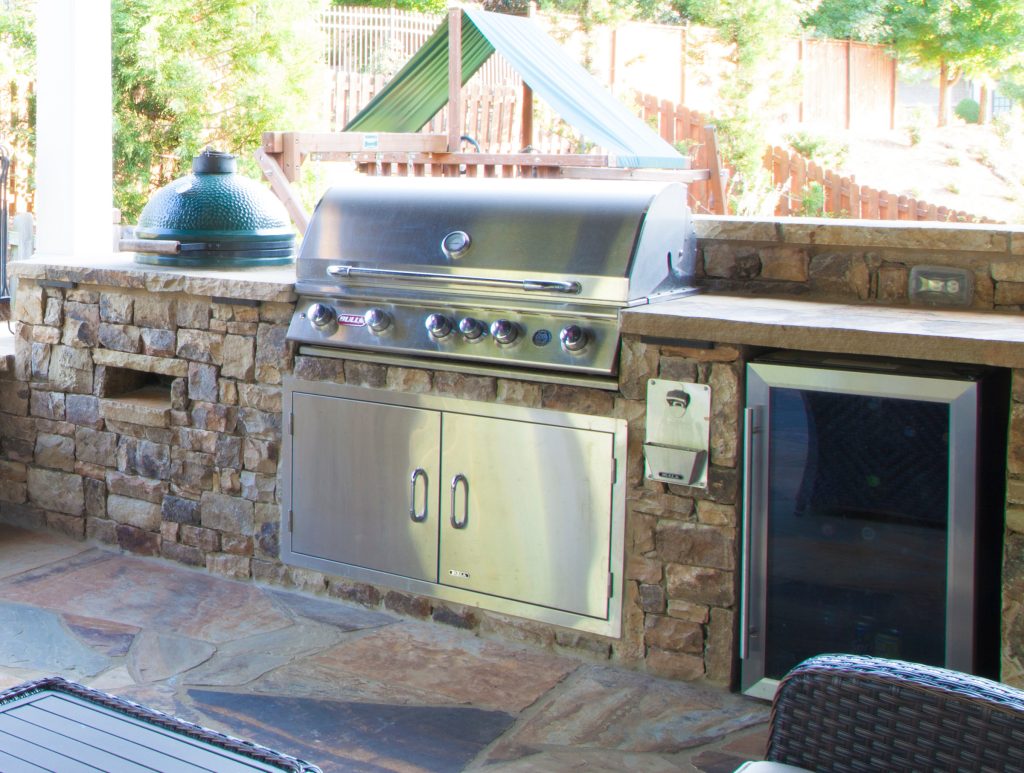 Bull BBQ with large green egg. Double doors with wine fridge