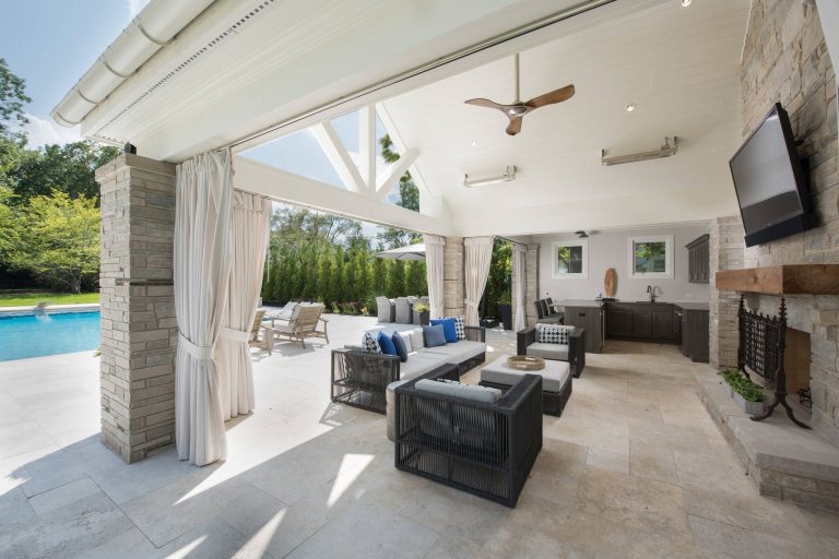 Cabana with stone fireplace and outdoor kitchen