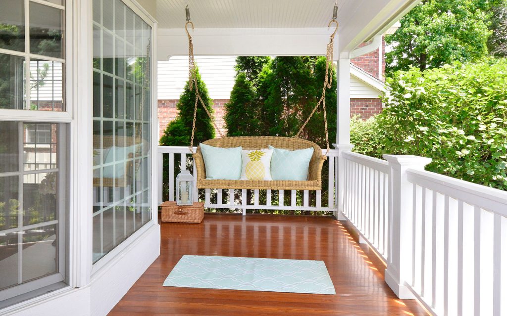 Cape Cod front porch with updated swing and floor stain