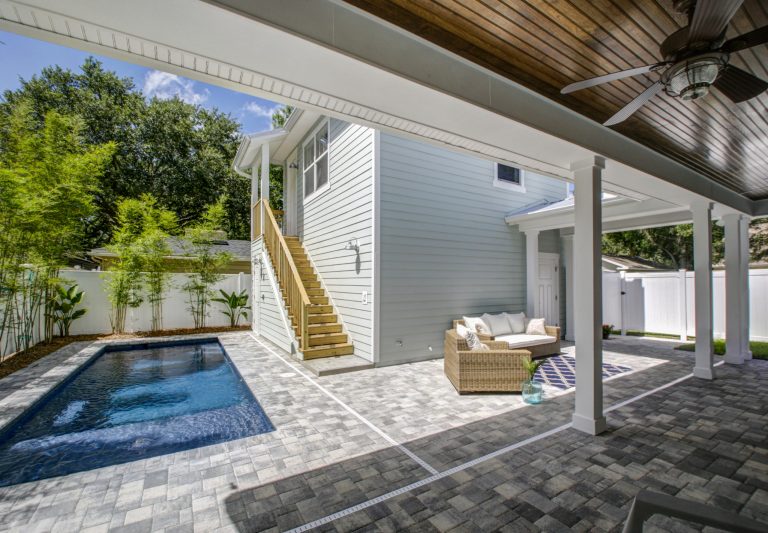 Casual and beachy courtyard, with natural materials and pavers. Ceilings are wood beadboard, stained. Fastpix, LLC