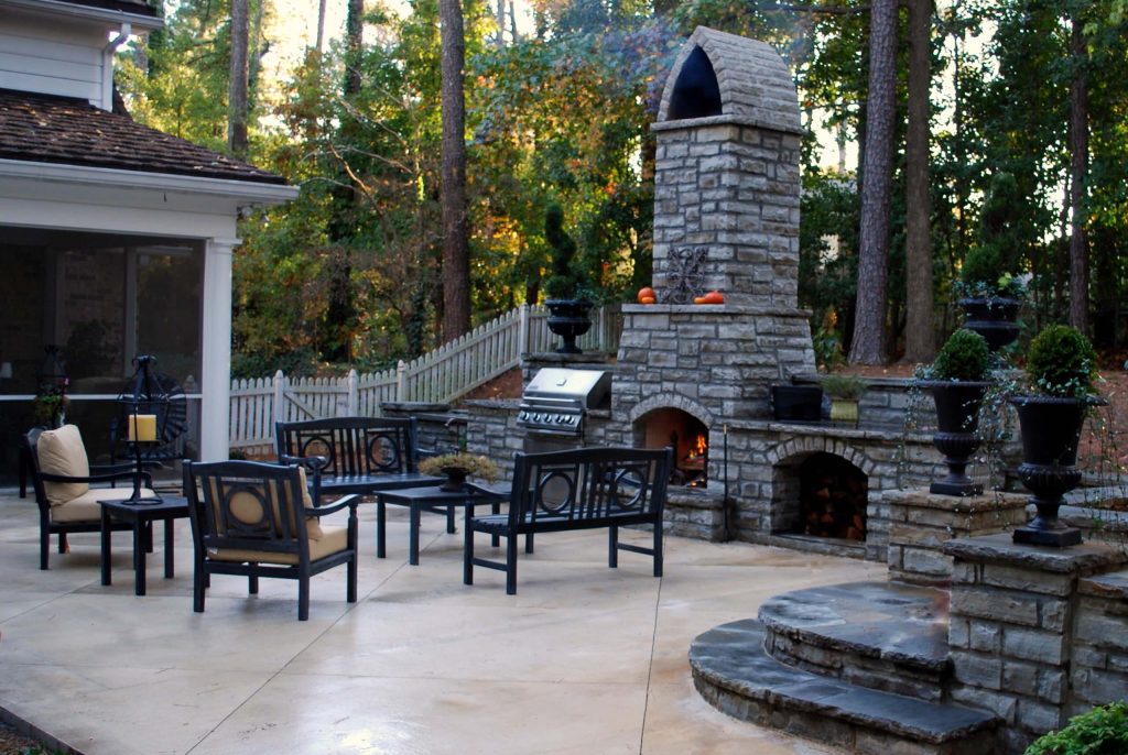 Charles Hodges of Charles Hodges ltd Gardens. Patio with stone fireplace and grill