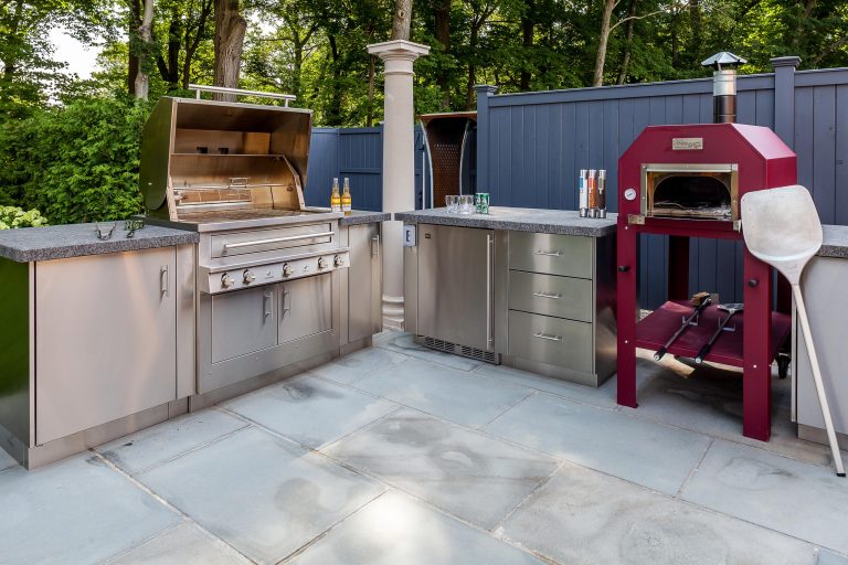 Christopher Bradbury, Glenwood Road Studios Outdoor kitchen with Kalamazoo cabinets, two refrigerators, sink, Hybrid barbeque and Happy Pizza Oven. Counter tops dark grey granite.