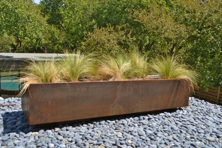 Close up of patina planter on patio roof - patina with irrigation.