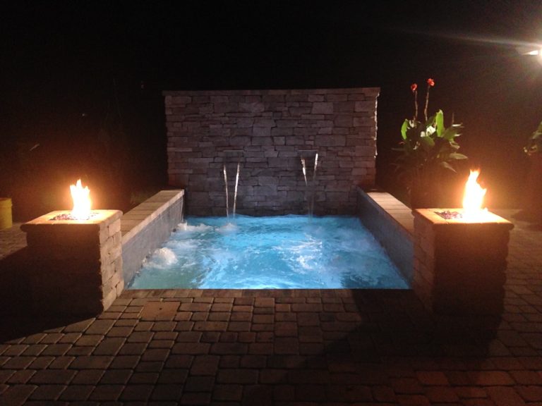 Cocktail Pool (Heated with 12 Therapy Jets) with 2 Shear Descent Falls and 2 Fire Features accented with stone veneer
