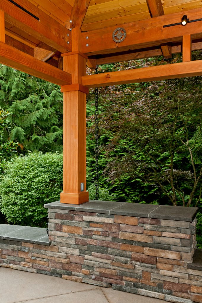 Column-beam-rafter connection is custom fabricated plate steel to minimize exposed hardware. 6x6 columns are cast into 3' deep footings and wrapped with 1x8 for concealed electrical components.