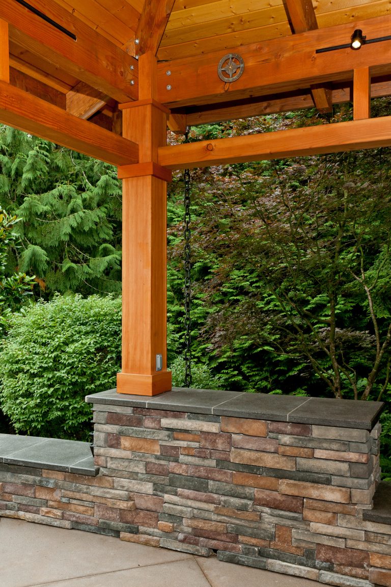 Column-beam-rafter connection is custom fabricated plate steel to minimize exposed hardware. 6x6 columns are cast into 3' deep footings and wrapped with 1x8 for concealed electrical components.