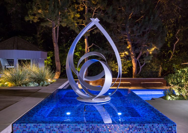 Commissioned uplit sculpture appears to float above its iridescent glass tiled perimeter overflow base. Photographer: Christian Terry