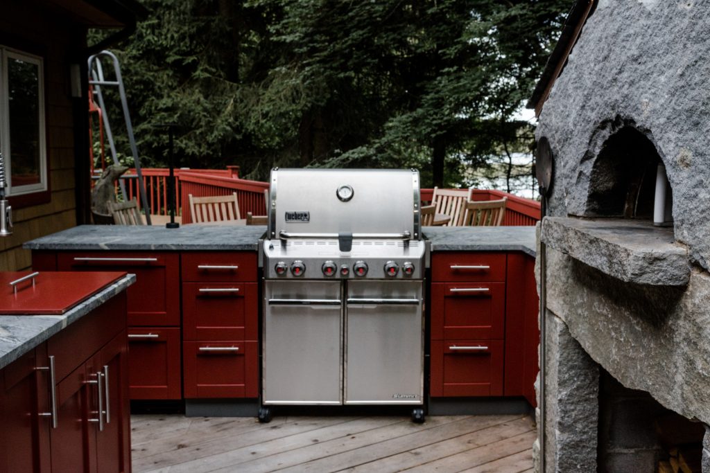 Complete outdoor kitchen on a raised deck including a new wood burning stone pizza oven.