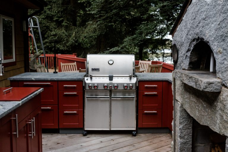 Complete outdoor kitchen on a raised deck including a new wood burning stone pizza oven.
