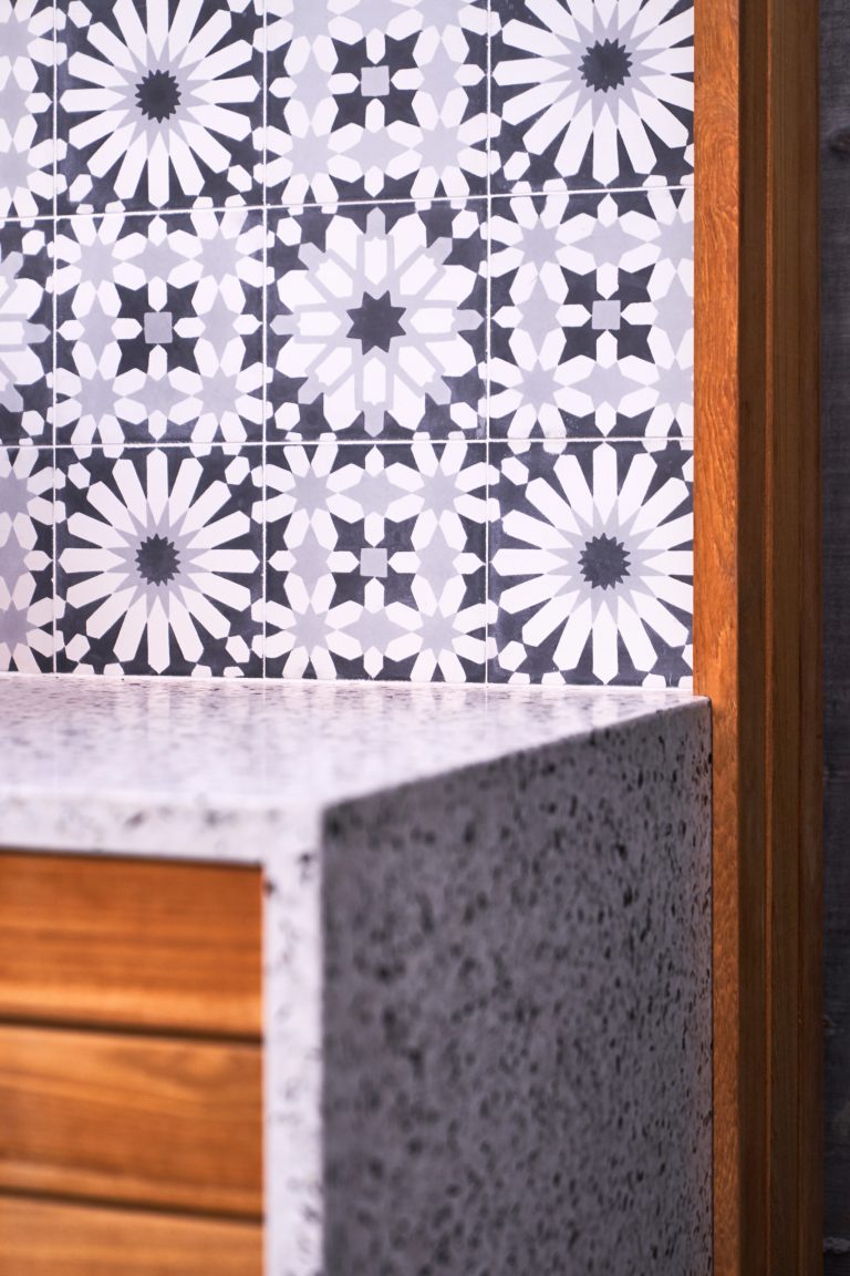 Concrete Collaborative waterfall countertop, Ann Sacks cement tiles and Teak Wood surround.