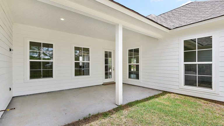 Concrete back porch photo in New Orleans with a roof extension by HU-407696 | Outdoor Photos | Porch | Landscaping | Landscape Design | Outdoor Living Space | Porch Design Ideas | Outdoor Living Space Ideas | Backyard Design