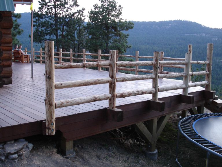 Conventional framed deck finished with hardwood decking & log railing/steps.