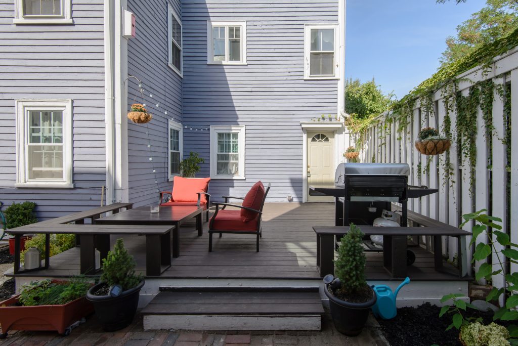 Cordovan Brown BEHR Deckover, hydrangeas, Lowes outdoor furniture. Scott Booth Photography, Julie Nelson from J. Barrett RealtyInspiration for a timeless side porch remodel in Boston with decking by Casey Elizabeth Designs | Outdoor Photos | Porch | Landscaping | Landscape Design | Outdoor Living Space | Porch Design Ideas | Outdoor Living Space Ideas | Backyard Design