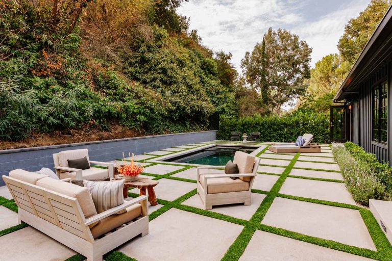 Cottage backyard concrete paver and rectangular natural pool photo in Los Angeles