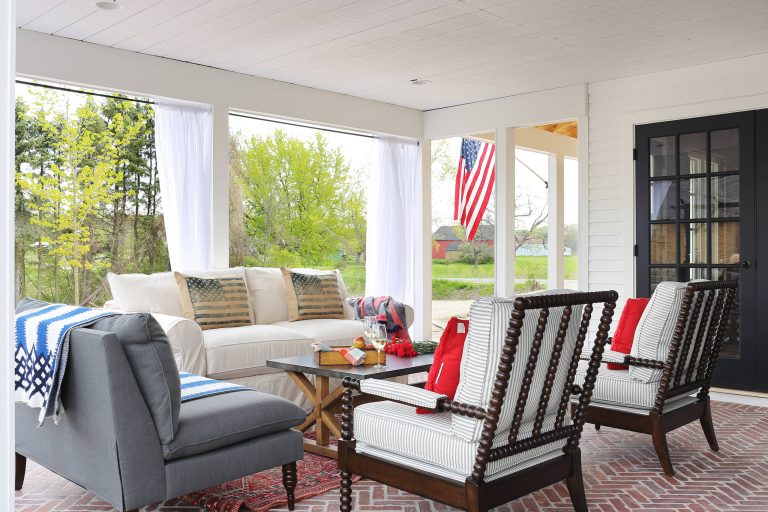 Country brick side porch photo in Grand Rapids with a roof extension by Paradigm Renovation | Outdoor Photos | Porch | Landscaping | Landscape Design | Outdoor Living Space | Porch Design Ideas | Outdoor Living Space Ideas | Backyard Design