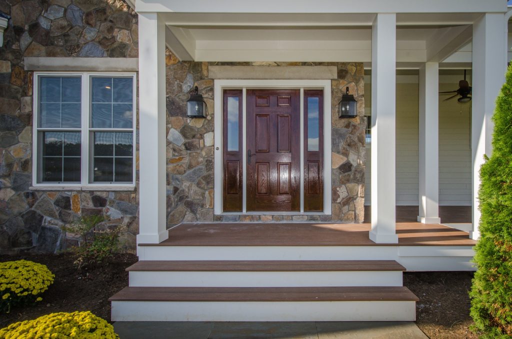 Country front porch photo in DC Metro with decking and a roof extension by Fairhaven Homes | Outdoor Photos | Porch | Landscaping | Landscape Design | Outdoor Living Space | Porch Design Ideas | Outdoor Living Space Ideas | Backyard Design