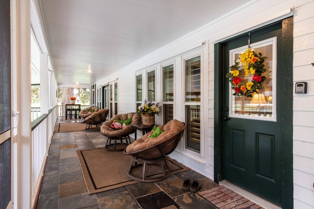 Country front porch photo in Houston with a roof extension by JC Remodeling & Restoration, LLC | Outdoor Photos | Porch | Landscaping | Landscape Design | Outdoor Living Space | Porch Design Ideas | Outdoor Living Space Ideas | Backyard Design