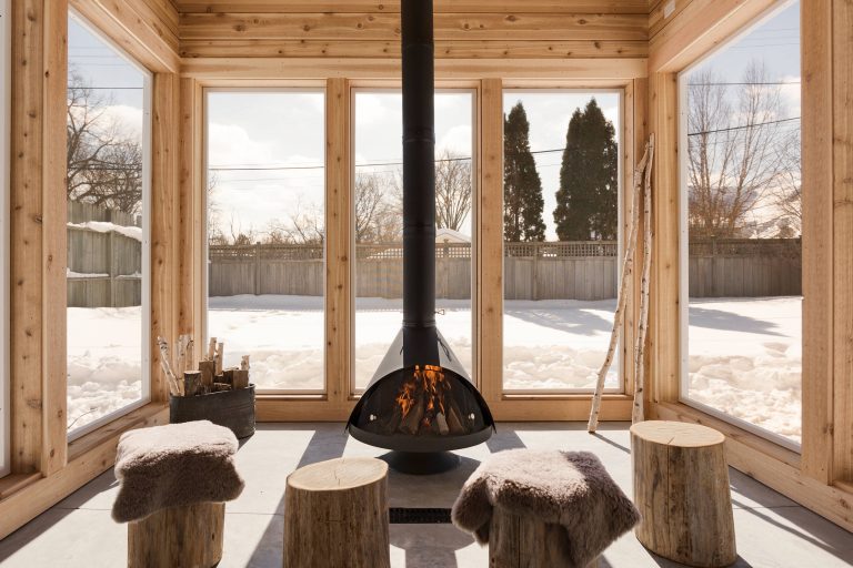 Country porch photo in Minneapolis with a fireplace and a roof extension by REFINED LLC | Outdoor Photos | Porch | Landscaping | Landscape Design | Outdoor Living Space | Porch Design Ideas | Outdoor Living Space Ideas | Backyard Design