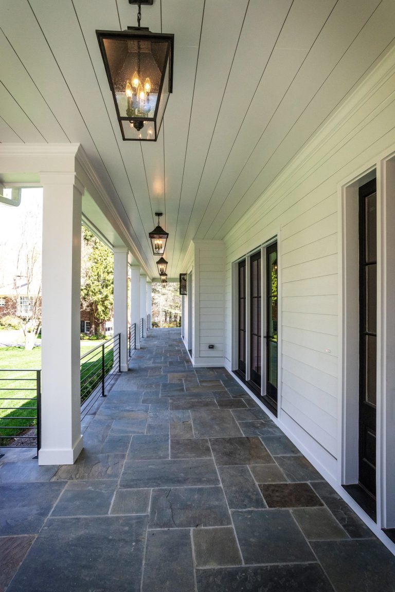 Country stone front porch photo in DC Metro with a roof extension by Dominion Lighting | Outdoor Photos | Porch | Landscaping | Landscape Design | Outdoor Living Space | Porch Design Ideas | Outdoor Living Space Ideas | Backyard Design