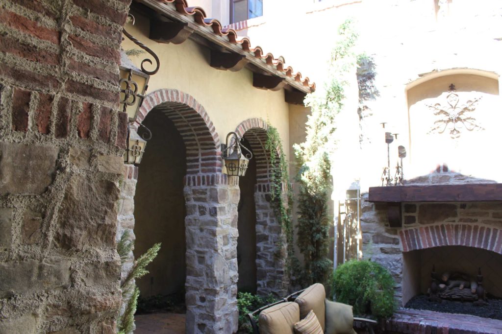 Courtyard Fireplac with stone and brick arches. Matched a picture taken in Italy