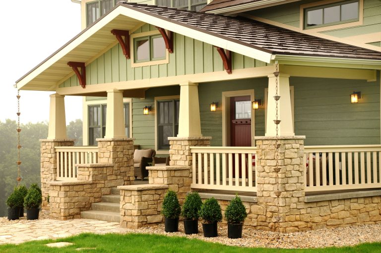 Covered front porch with stone columns. Photo by Hal Kearney