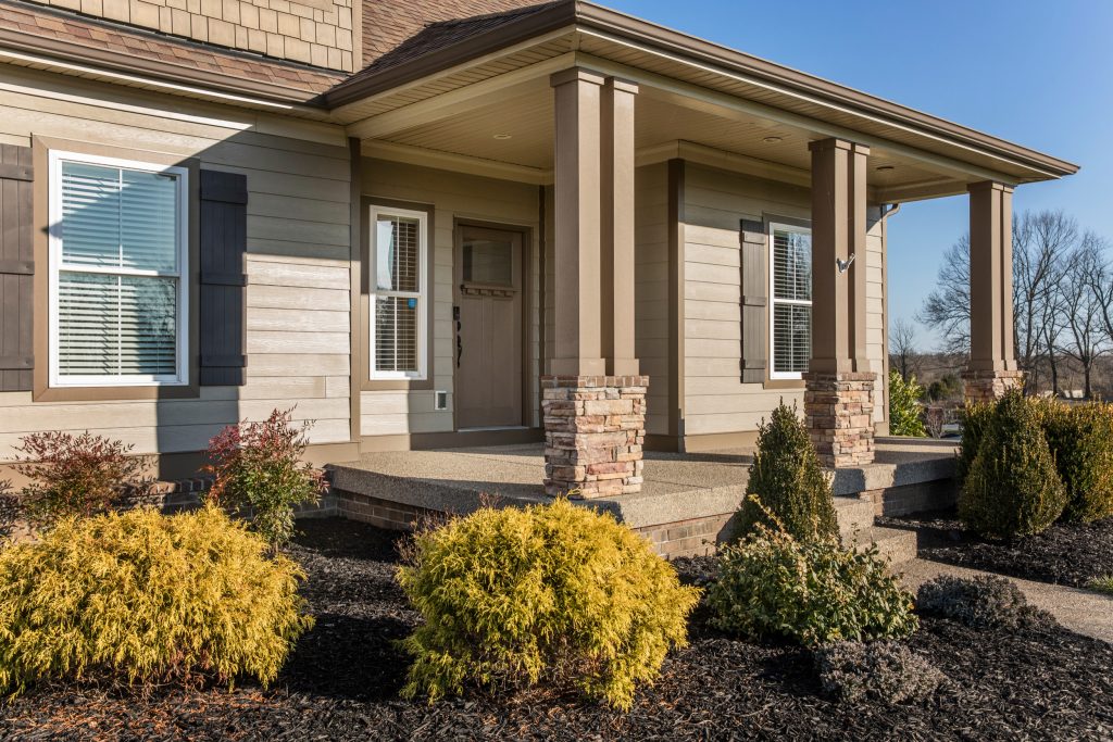 Covered porch with tan supporting beams