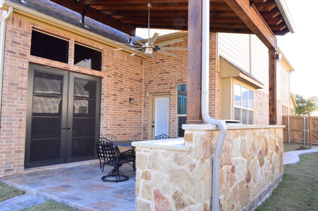 Custom Fort Worth TX outdoor kitchen with stain and stamp patio and pergola roof.