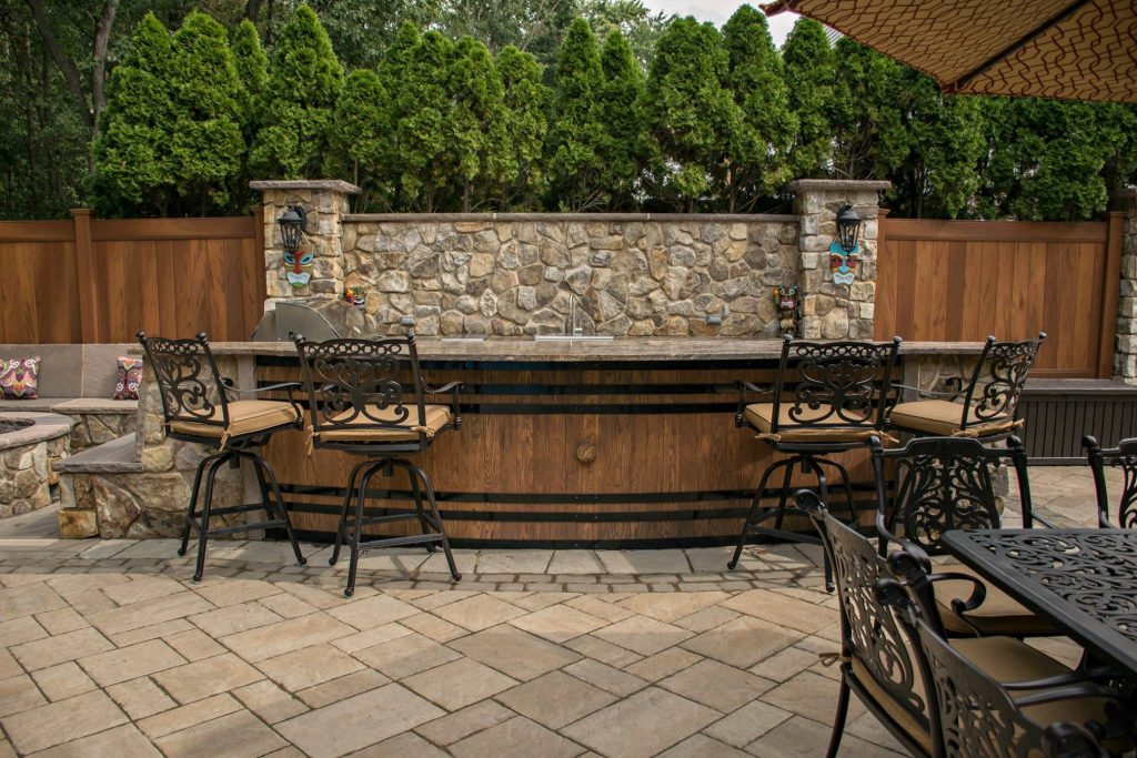 Custom Kitchen with Wine Barrel Front, granite countertops and stone backsplash