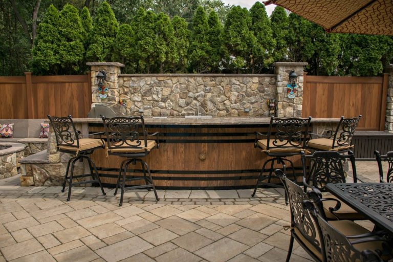 Custom Kitchen with Wine Barrel Front, granite countertops and stone backsplash
