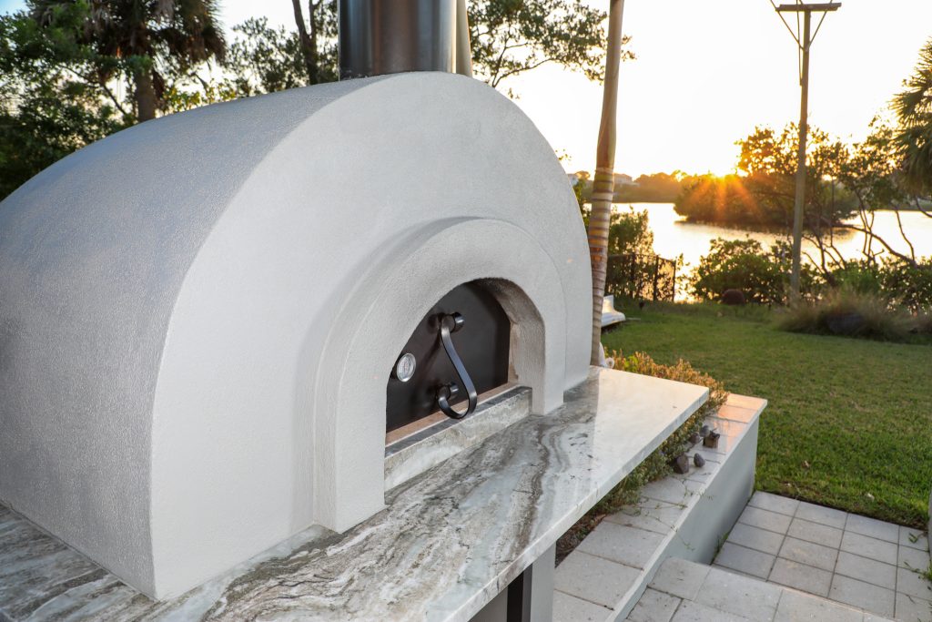 Custom built pizza oven with counter prep station including storage.