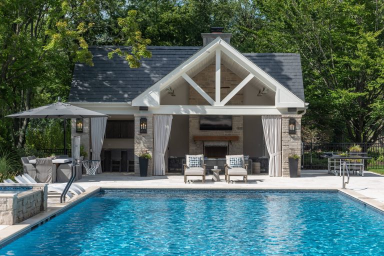 Custom cabana with fireplace, tv, living space, and dining area