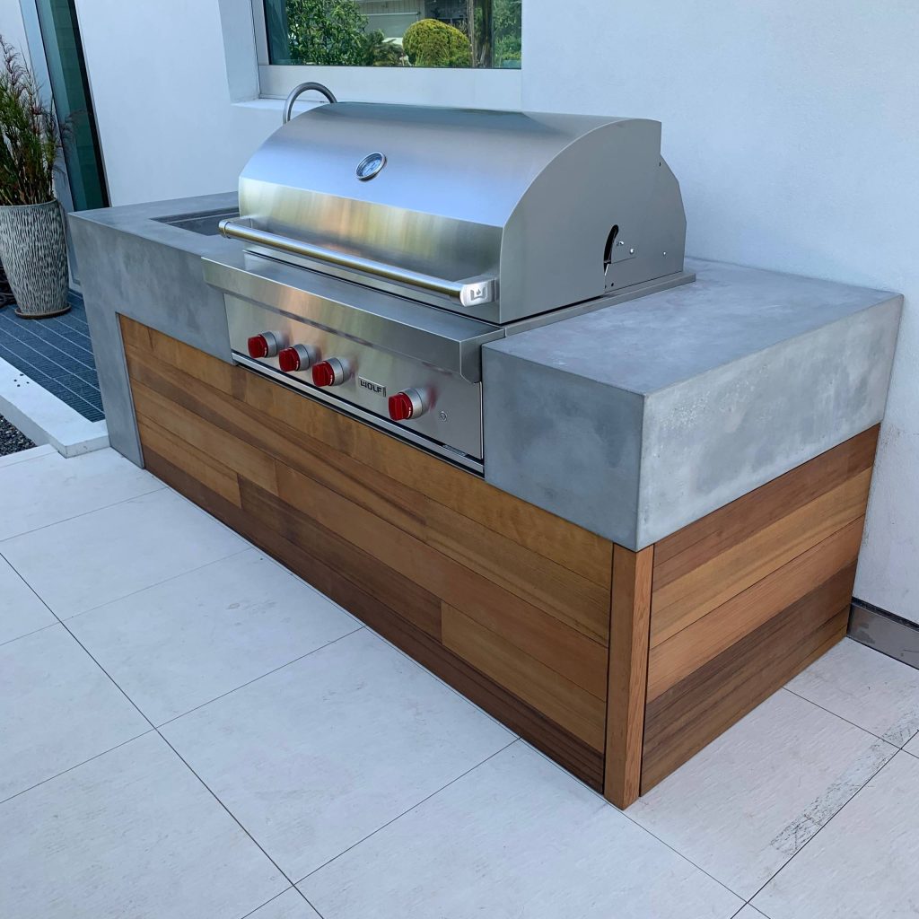Custom concrete and wood bbq surround.
