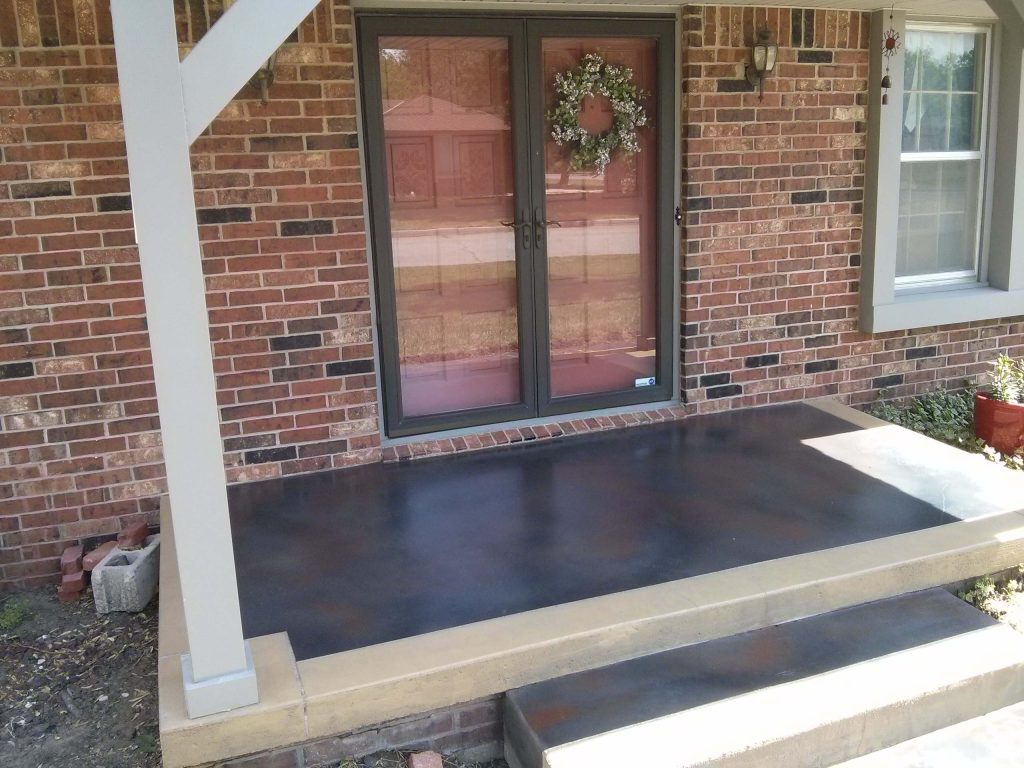 Custom design patio. Saw cuts to resemble cut tile in colors to match masonry. Porch cut and stained to look like stone inlays.