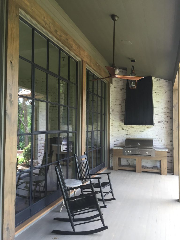 Custom grill cabinet and hood. Iron windows and doors.